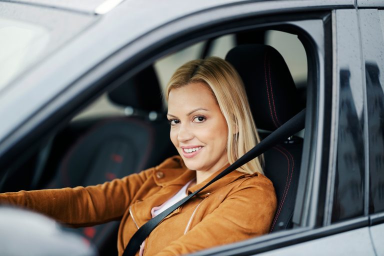 a happy woman who has saved money on comparing auto insurance rates